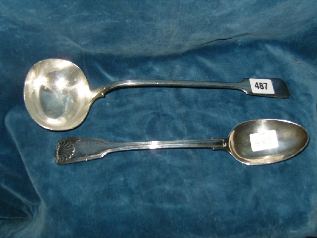 Appraisal: A Victorian silver fiddle pattern ladle London oz together with