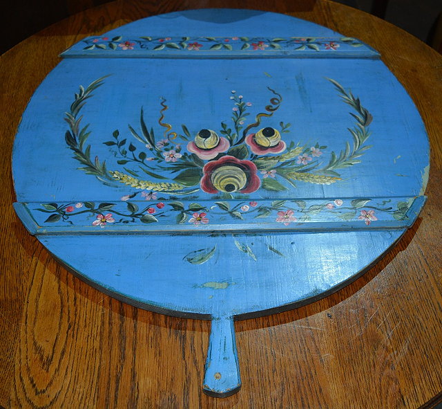 Appraisal: A continental blue painted large bread boardpainted with floral designs