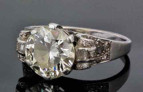 Appraisal: A 's silvery metal mounted solitaire diamond ring the brilliant