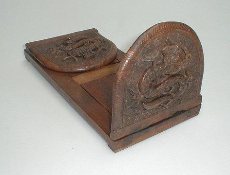 Appraisal: An Oriental hardwood bookslide the rounded end panels carved in