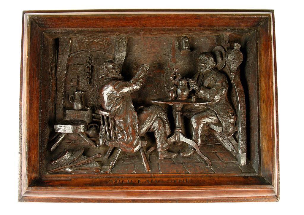 Appraisal: A deep relief carved oak panel by J M Kirkbride