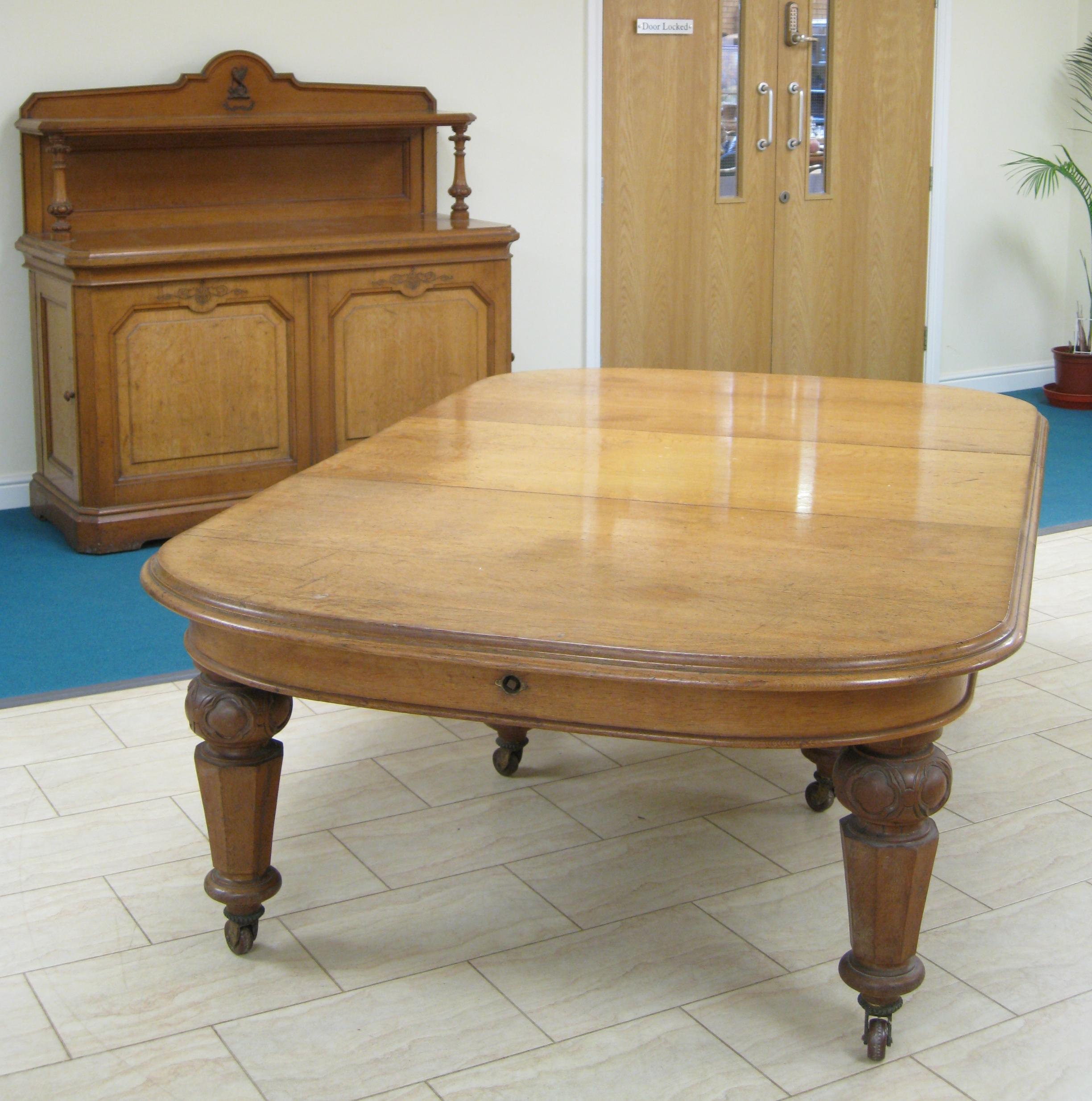 Appraisal: A Victorian oak Extending Dining Table with rounded ends one