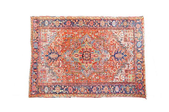 Appraisal: ORIENTAL RUG Heriz Room size with blue border salmon ground