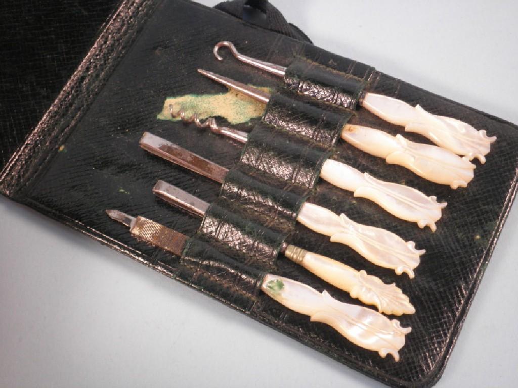 Appraisal: A mother of pearl handled manicure set in a green