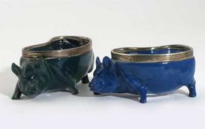 Appraisal: Two Royal Doulton Titanium glaze pigs each set with silver