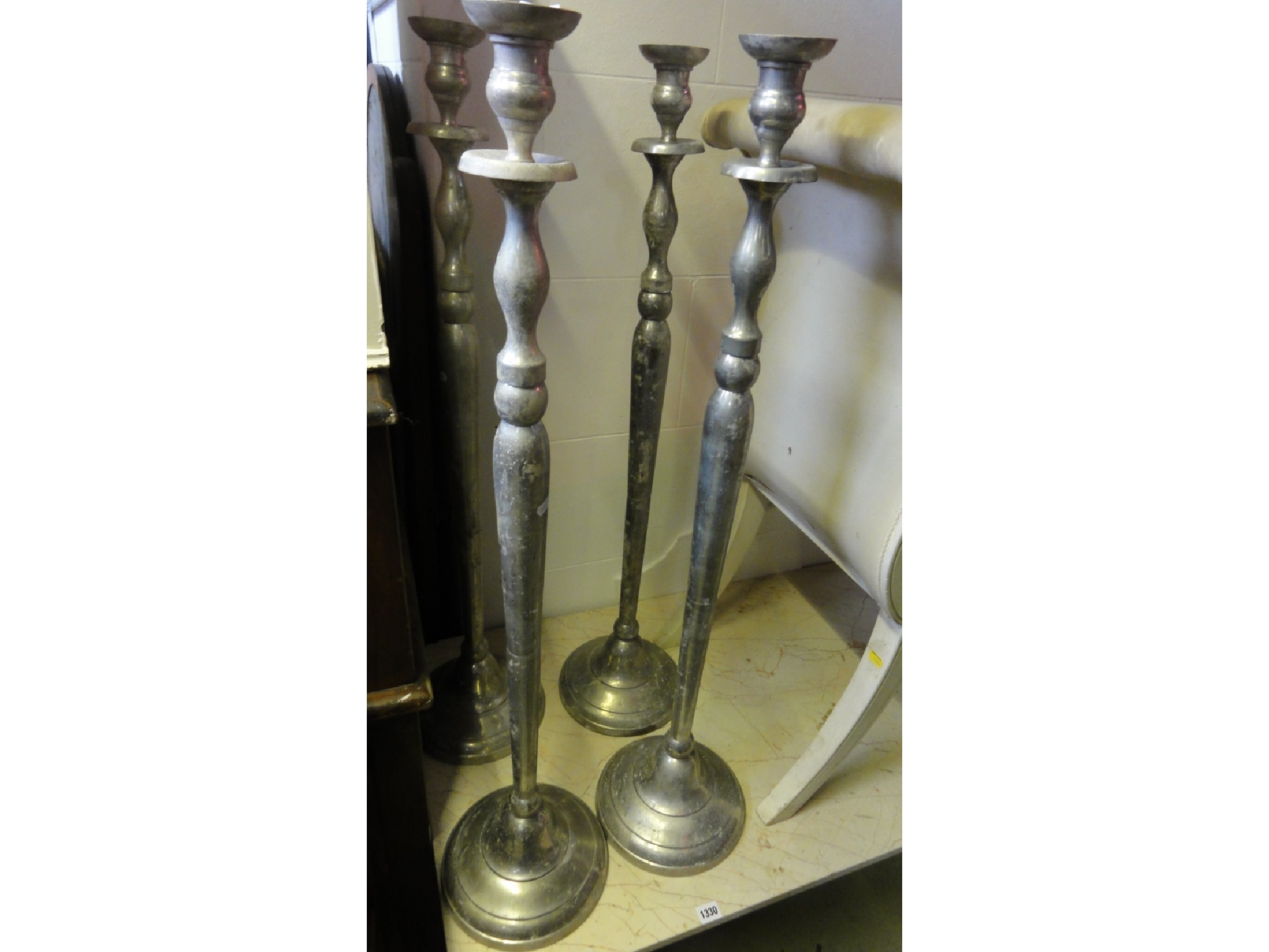 Appraisal: A set of four cast metal alloy floor standing candlesticks