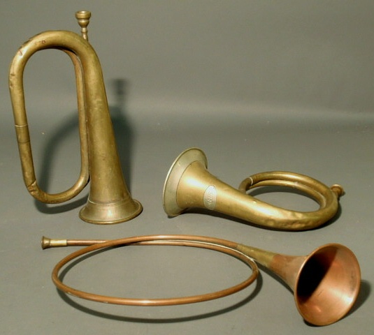 Appraisal: Brass hunting horn copper hunting horn and a brass bugle