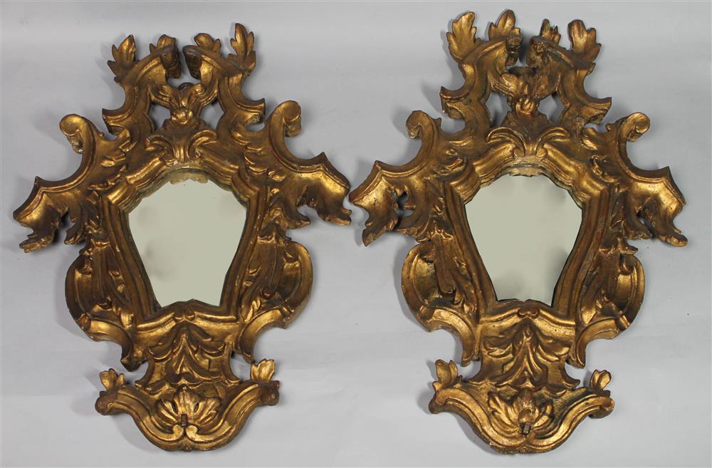 Appraisal: PAIR OF ITALIAN BAROQUE STYLE GILTWOOD WALL MIRRORS pierced crest