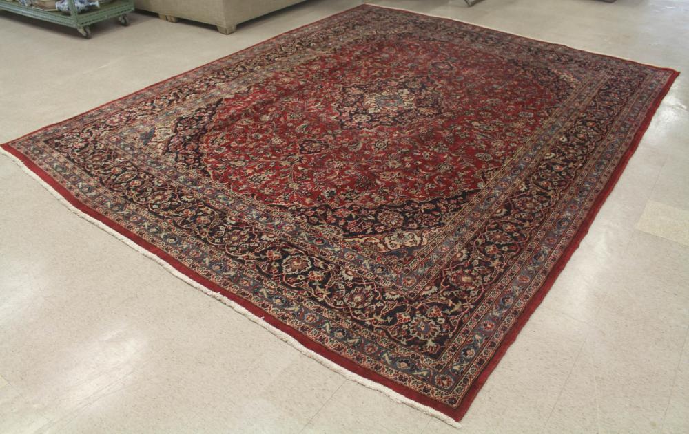 Appraisal: HAND KNOTTED PERSIAN CARPET floral and central floral medallion design