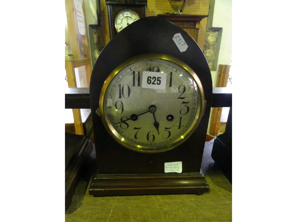 Appraisal: An Edwardian mantle clock with lancet shaped case silvered dial