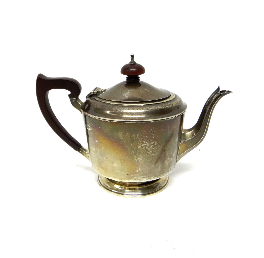 Appraisal: A silver teapot of tapered cylindrical form with a faceted