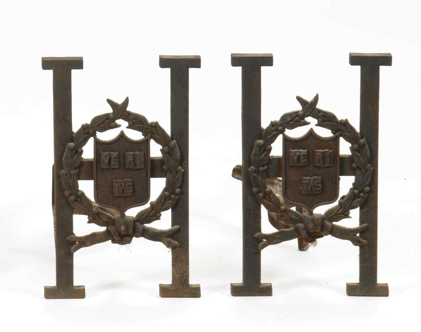 Appraisal: PAIR OF HARVARD CAST IRON ANDIRONSEarly th CenturyIn the form