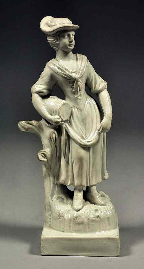 Appraisal: An early Staffordshire white pearlware figure of a lady carrying