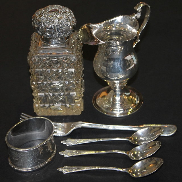 Appraisal: A GEORGIAN STYLE SILVER HELMET SHAPED JUG with shaped handle