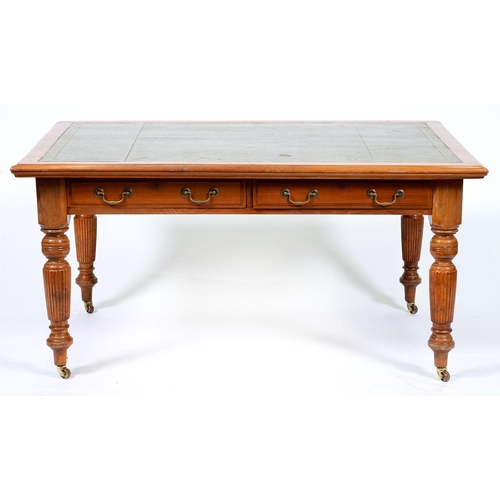 Appraisal: An Edwardian walnut library table with leather inlet top fitted