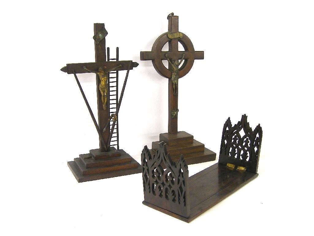 Appraisal: Two wooden crucifixes modelled with metal figures of Christ upon