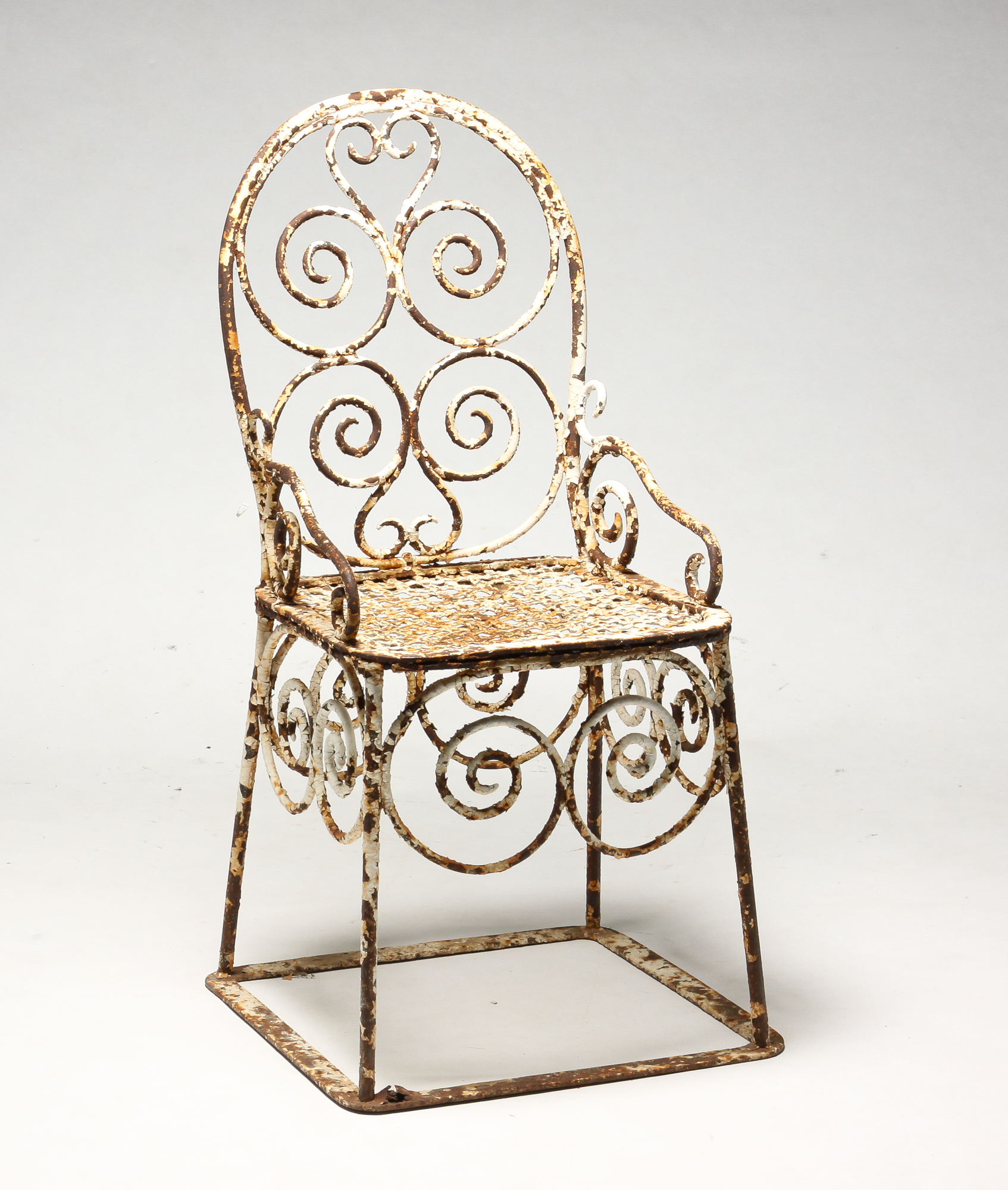 Appraisal: AMERICAN WROUGHT IRON GARDEN ARMCHAIR Early th century Scrolled designs