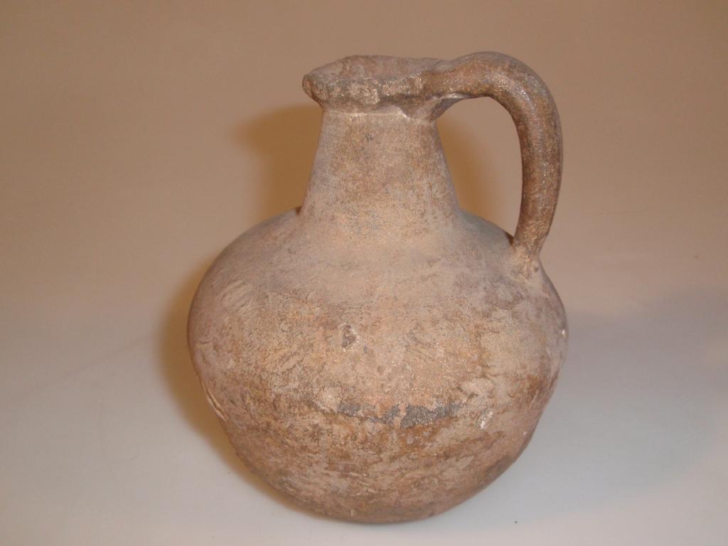 Appraisal: An ancient handled pottery bottle with pouring lip cm high