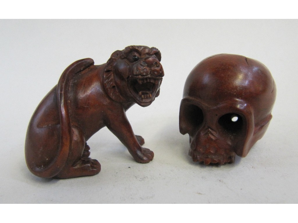 Appraisal: Lot comprising two Netsuke - Lion and a Skull