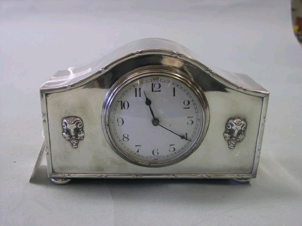 Appraisal: A silver plated mantel clock convex enamel dial single train