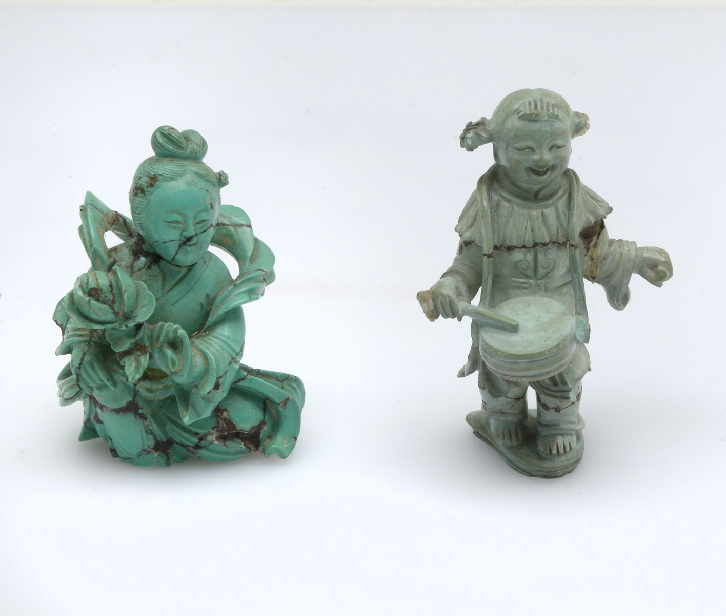 Appraisal: CHINESE CARVED TURQUOISE FEMALE FIGURES carved female figure playing a