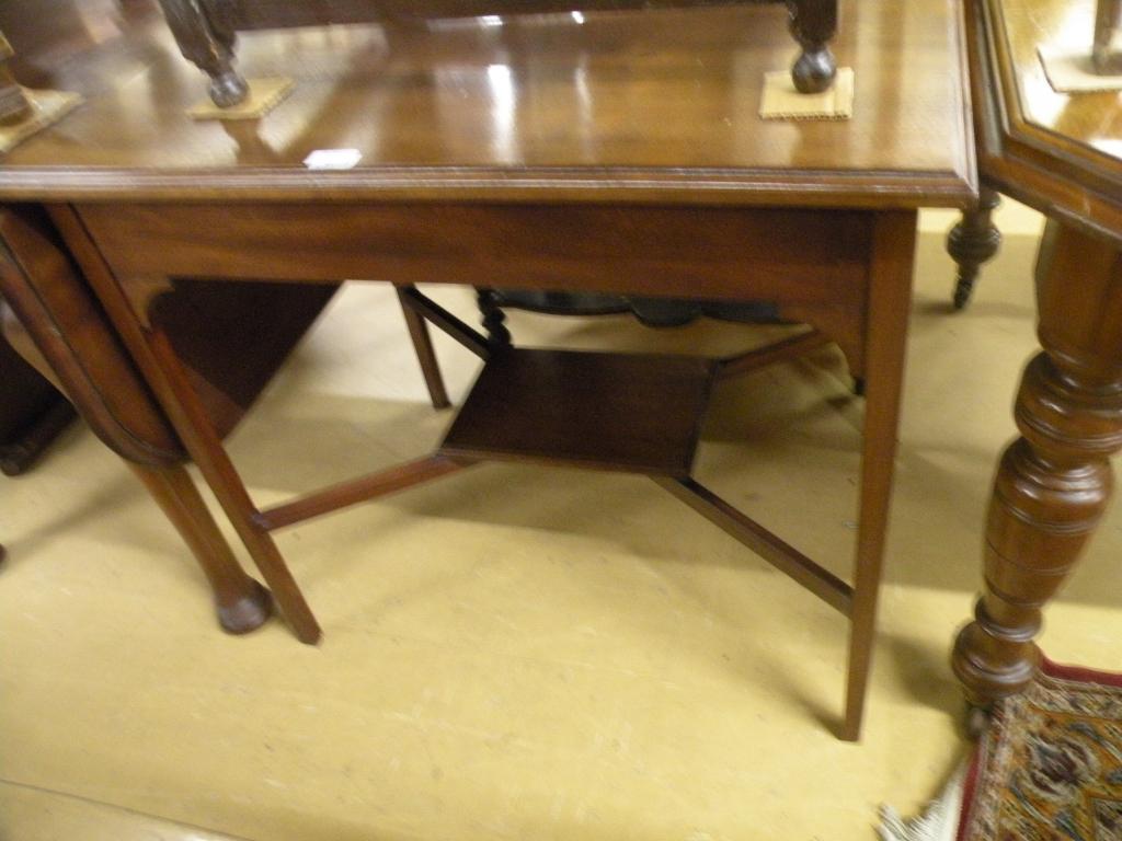 Appraisal: An Edwardian rectangular walnut two tier table