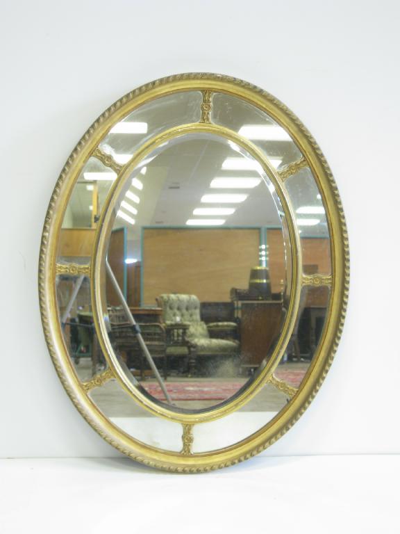 Appraisal: An Edwardian oval Wall Mirror with eight outer panels surrounding