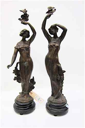 Appraisal: PAIR VICTORIAN SPELTER FIGURES woman in long flowing garments holding