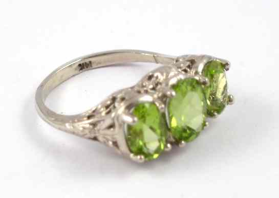 Appraisal: PERIDOT AND FOURTEEN KARAT WHITE GOLD RING set with three