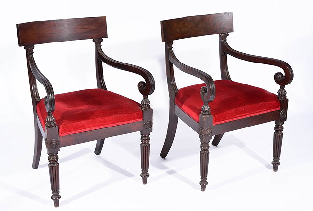 Appraisal: A PAIR OF LATE REGENCY MAHOGANY CARVER CHAIRS with reeded