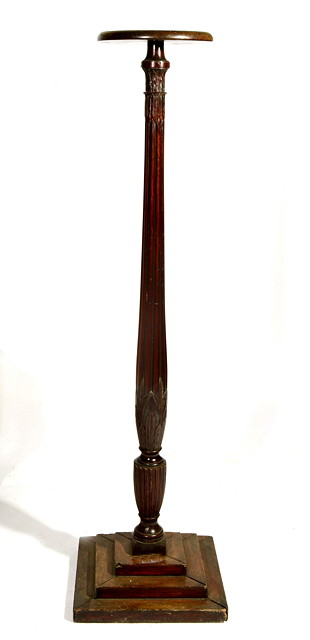 Appraisal: A MAHOGANY TORCHERE of carved and fluted column form on