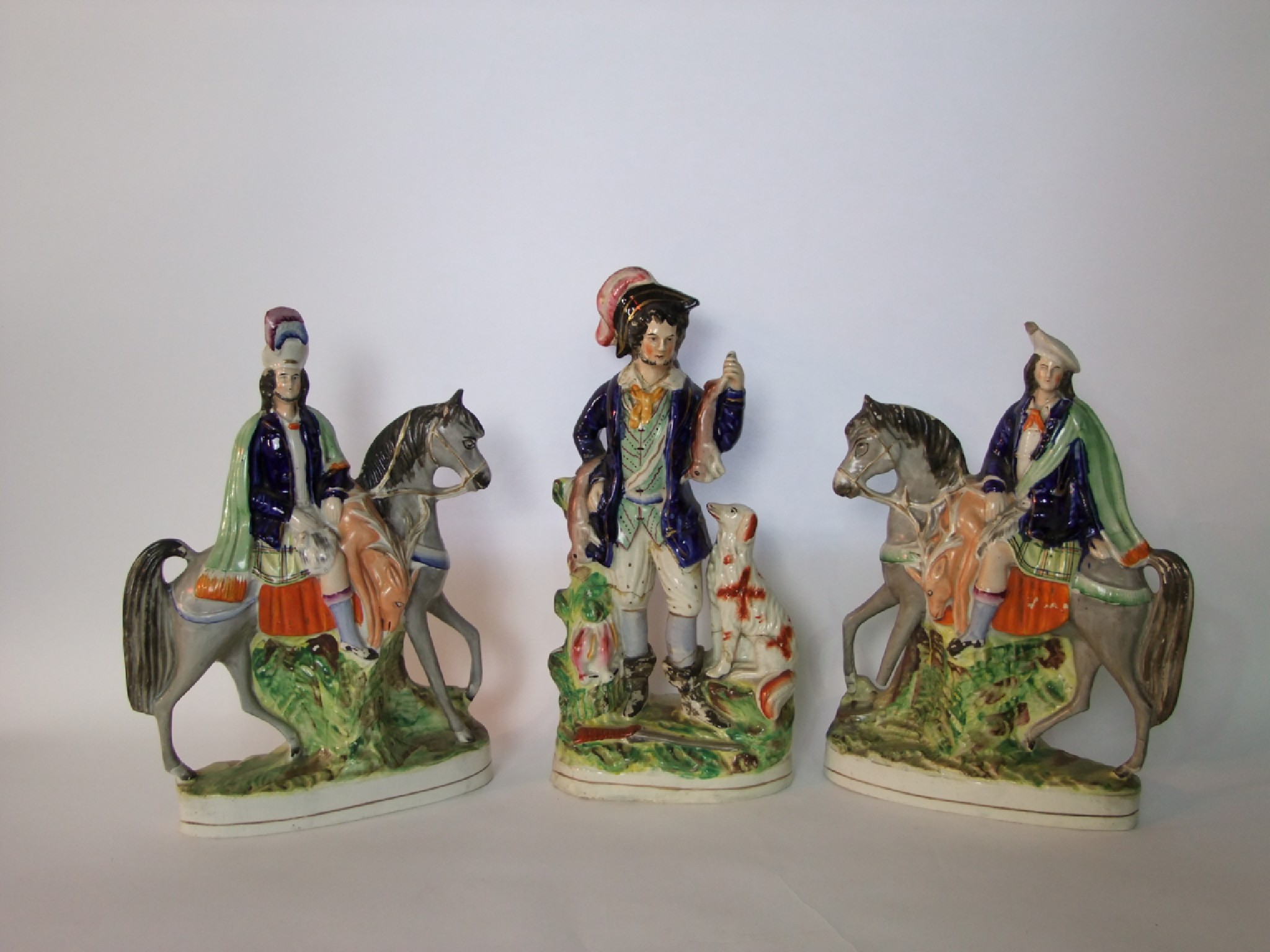 Appraisal: A pair of th century Staffordshire equestrian figures of sportsmen