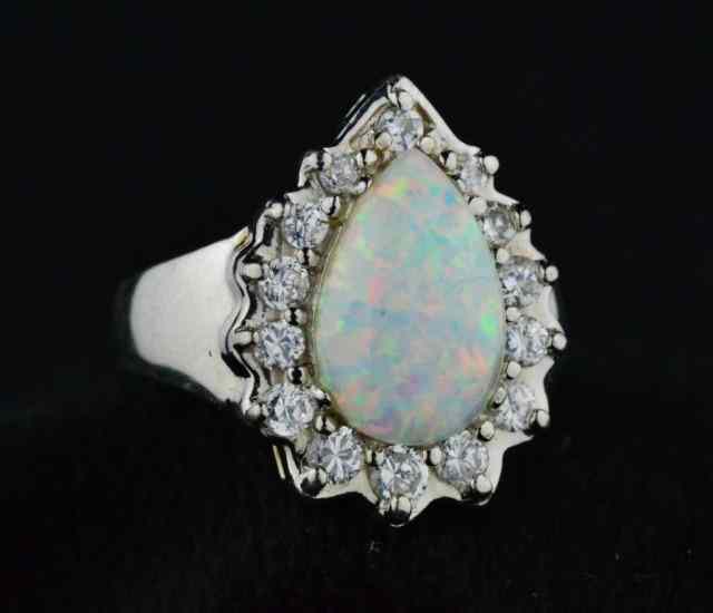 Appraisal: LADY'S OPAL DIAMOND RINGConsisting of one pear-shaped opal carats with