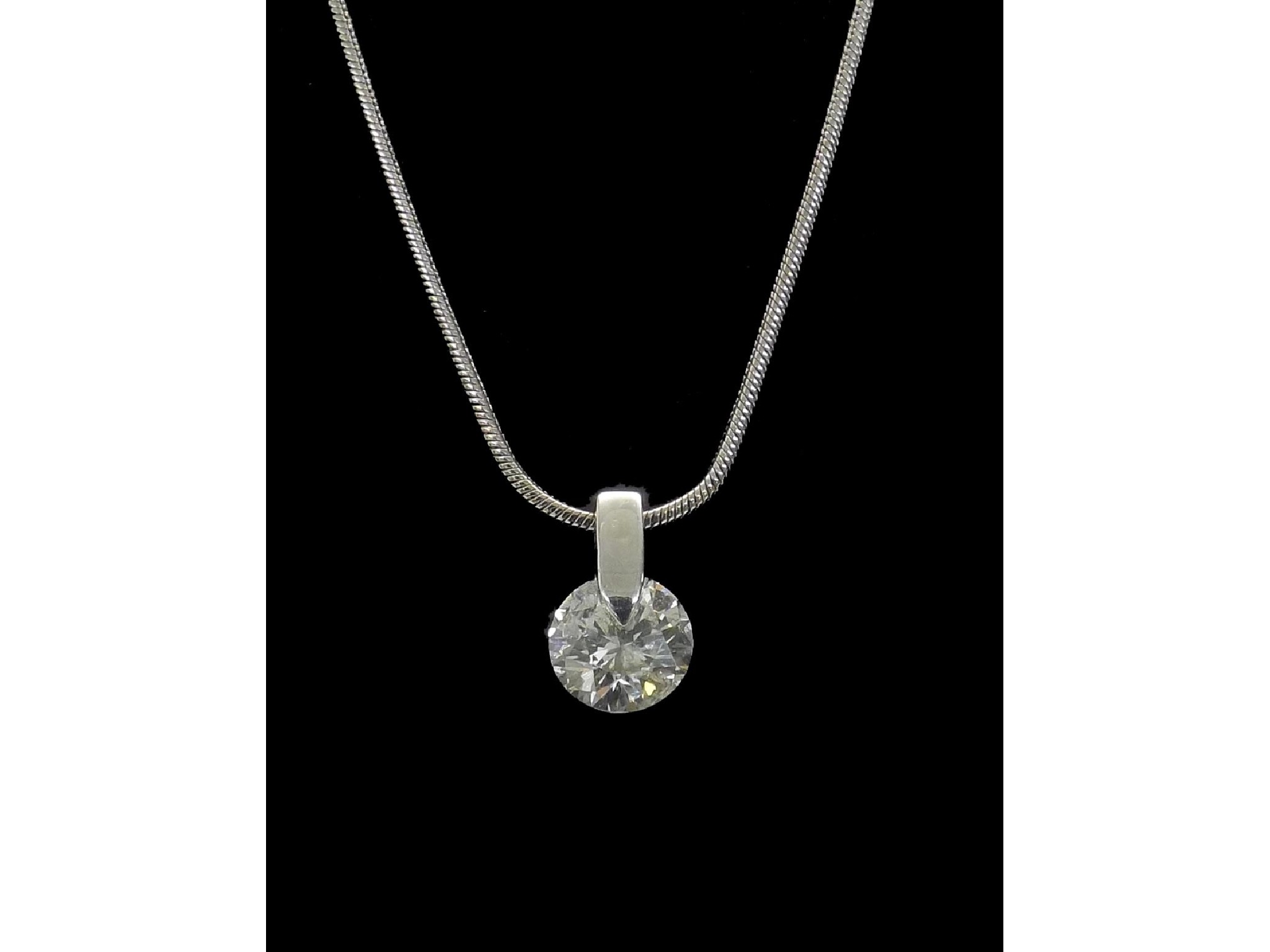 Appraisal: - -a Solitaire brilliant-cut diamond pendant on a slender ct