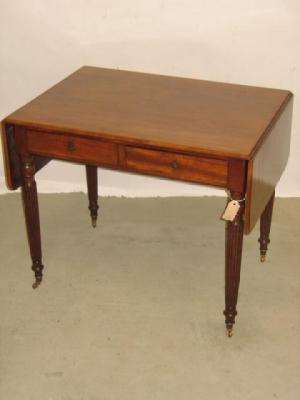 Appraisal: A MAHOGANY SOFA TABLE the rounded oblong top with stringing