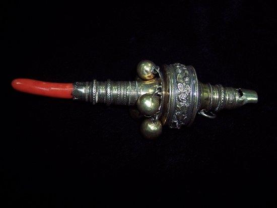 Appraisal: A William IV child's rattle with whistle terminal the body