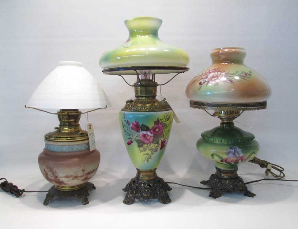 Appraisal: THREE ELECTRIFIED FLUID OIL TABLE LAMPS the milk-glass bodies hand