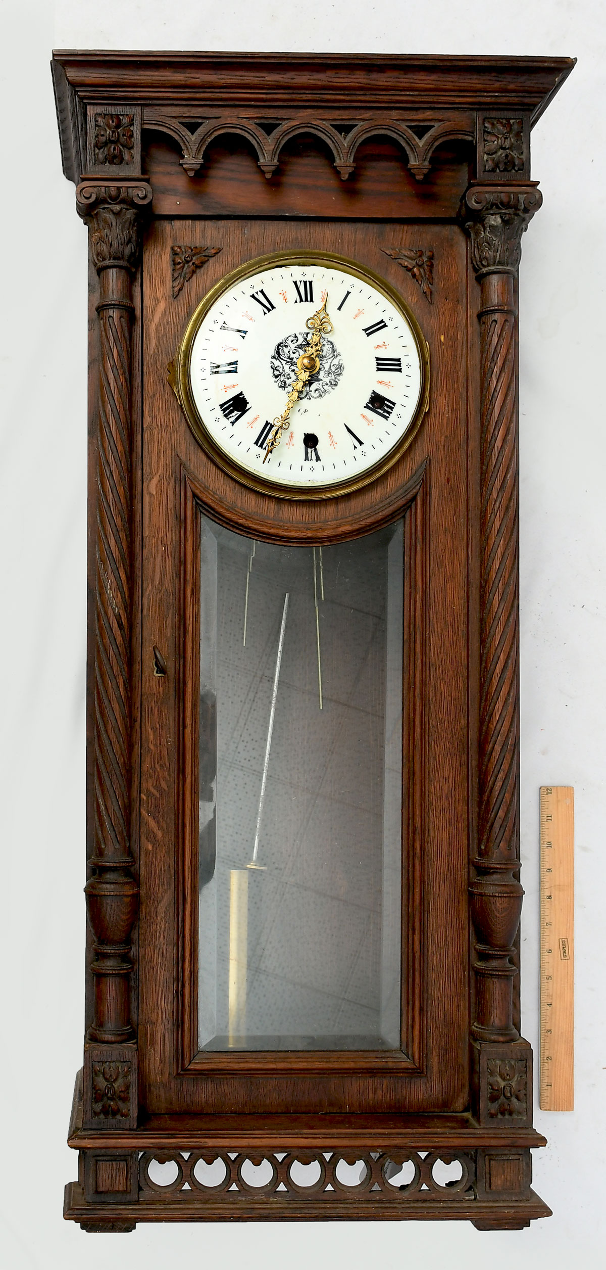 Appraisal: CARVED OAK REGULATOR WALL CLOCK Enameled face with painted accents