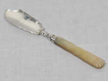 Appraisal: A Georgian silver butter knife with carved mother of pearl