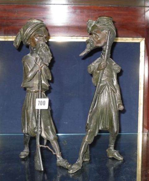 Appraisal: A pair of patinated metal figural candlesticks one modelled as