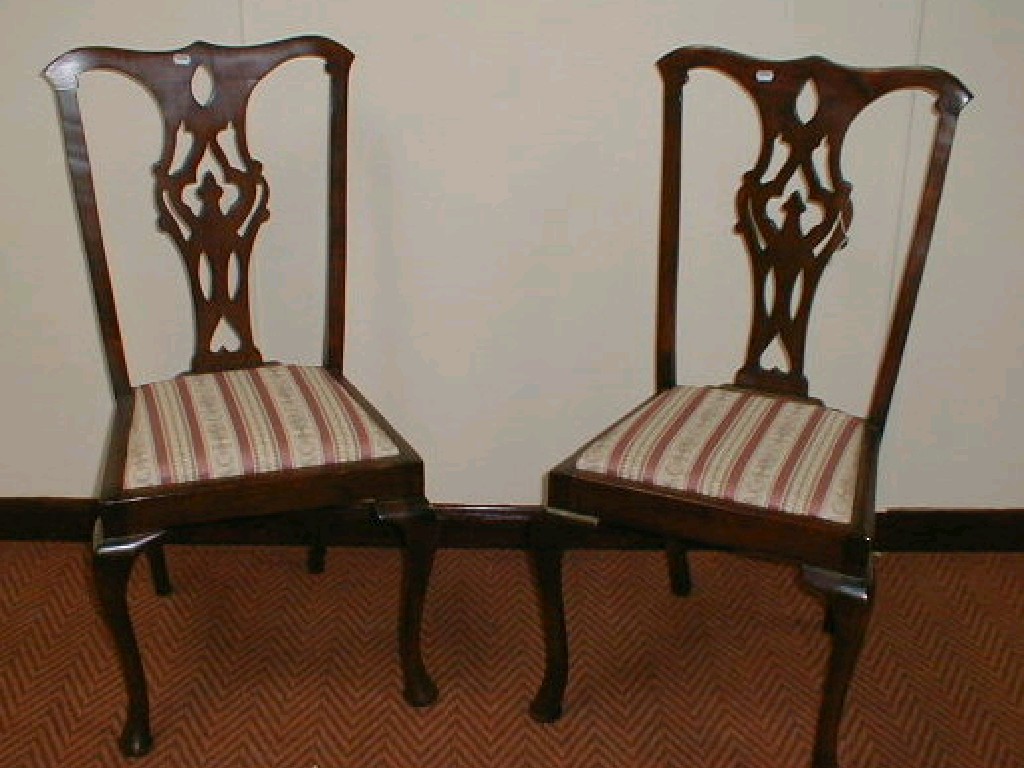 Appraisal: A pair of Chippendale style mahogany dining chairs