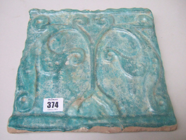 Appraisal: A Nishapur turquoise glazed tile relief moulded with leaf scrolls