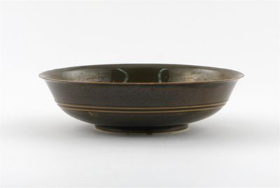 Appraisal: A Chinese brown-glazed dragon bowl the flared sides with a