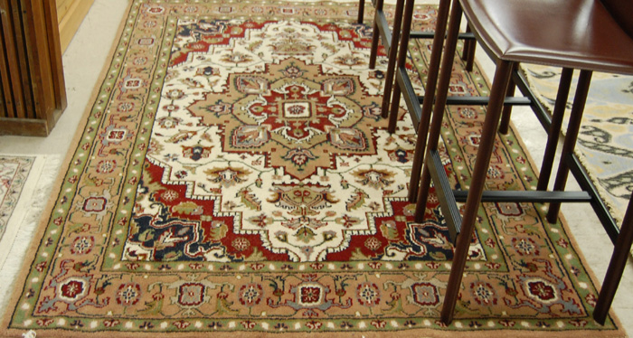 Appraisal: HAND KNOTTED ORIENTAL CARPET Indo-Heriz stylized floral and central floral