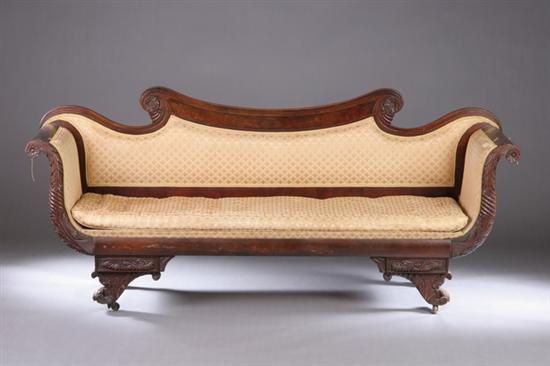 Appraisal: AMERICAN CLASSICAL CARVED MAHOGANY SOFA Circa Underscrolled crest above padded