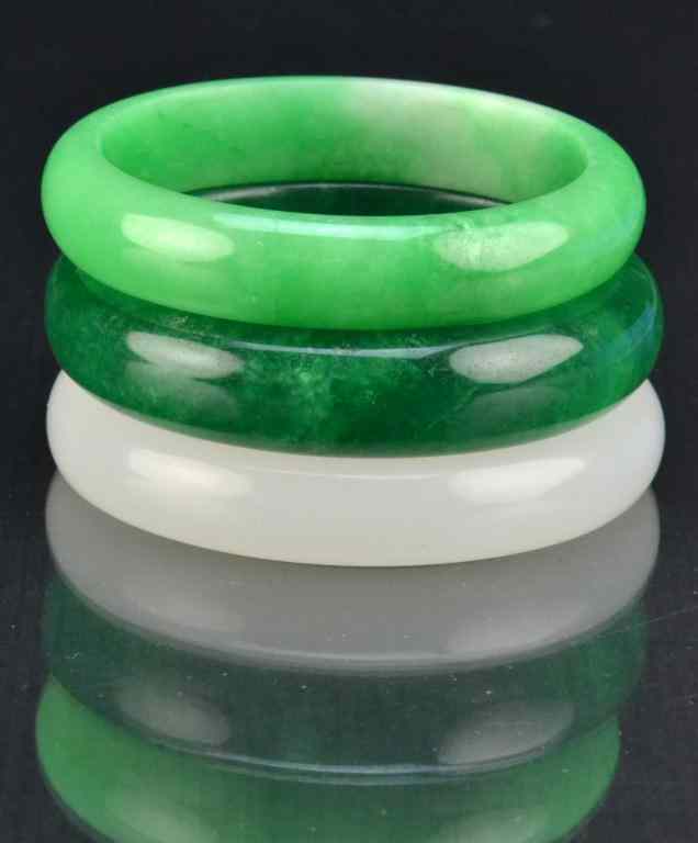 Appraisal: Chinese Jade Jadeite Bangle BraceletsAll uncarved one in white one