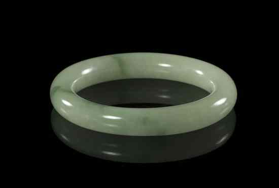 Appraisal: A Jadeite Bangle of light green hue with deeper green