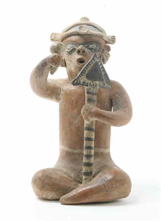 Appraisal: A Nayarit Style Pottery Figure depicted seated wearing numerous ear