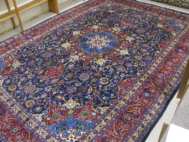 Appraisal: PERSIAN MASHAD CARPET floral and central floral medallion design on