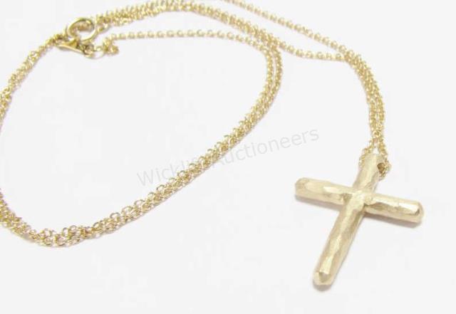 Appraisal: A Tiffany K yellow gold cross necklace by designer Paloma